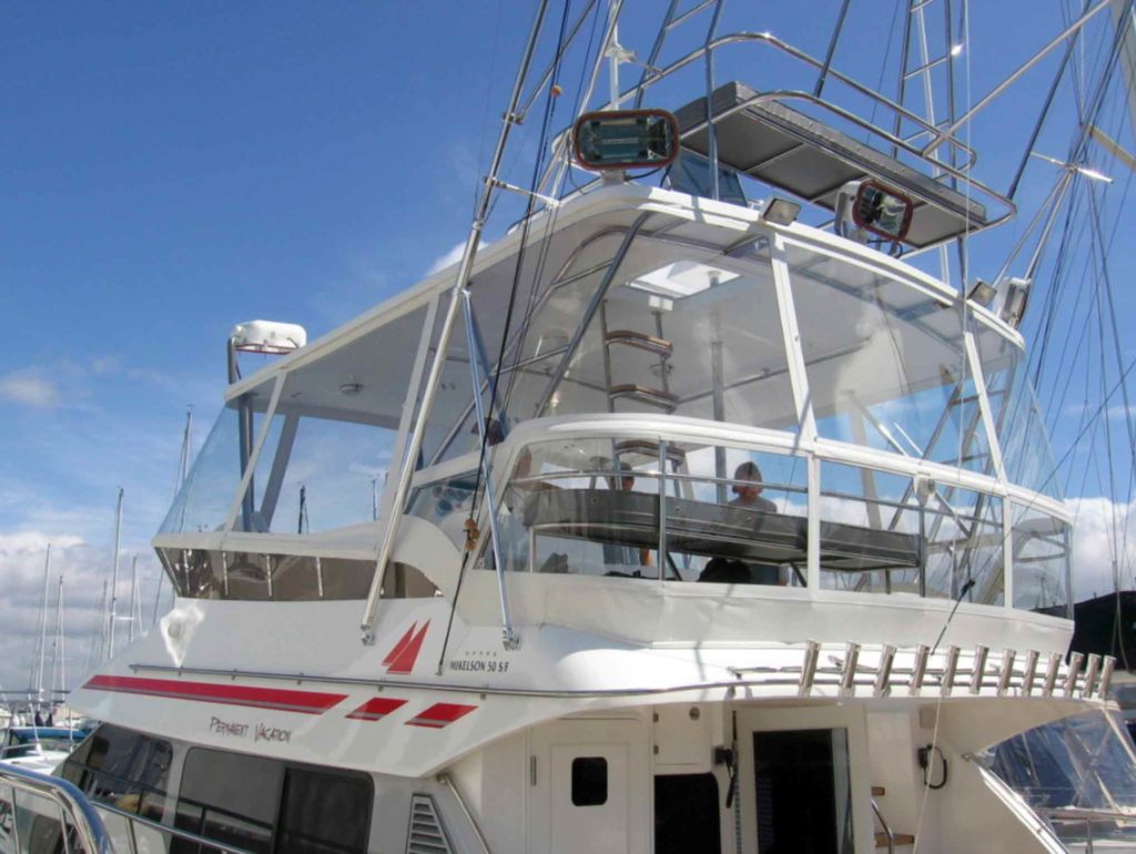 A fully enclosed flybridge with Rainier Marine boat windows on a 50ft power boat.