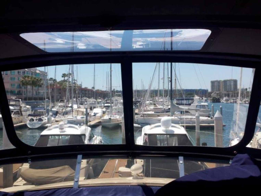 The view from the inside one of our navy blue trimmed boat canvas enclosures with a sun roof.